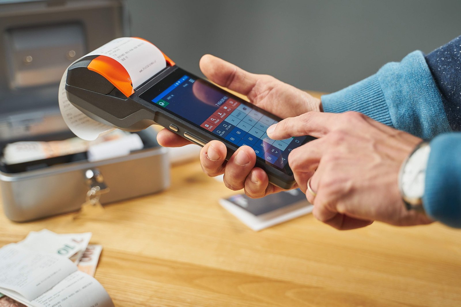 Person using a sleek digital payment terminal